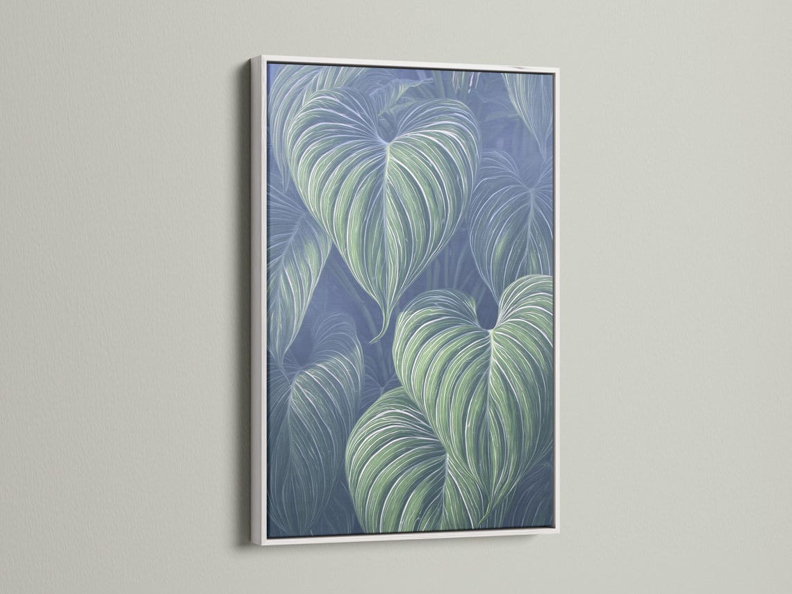 Mockup showing a framed botanical leaf artwork with mint green leaves on a navy-blue background