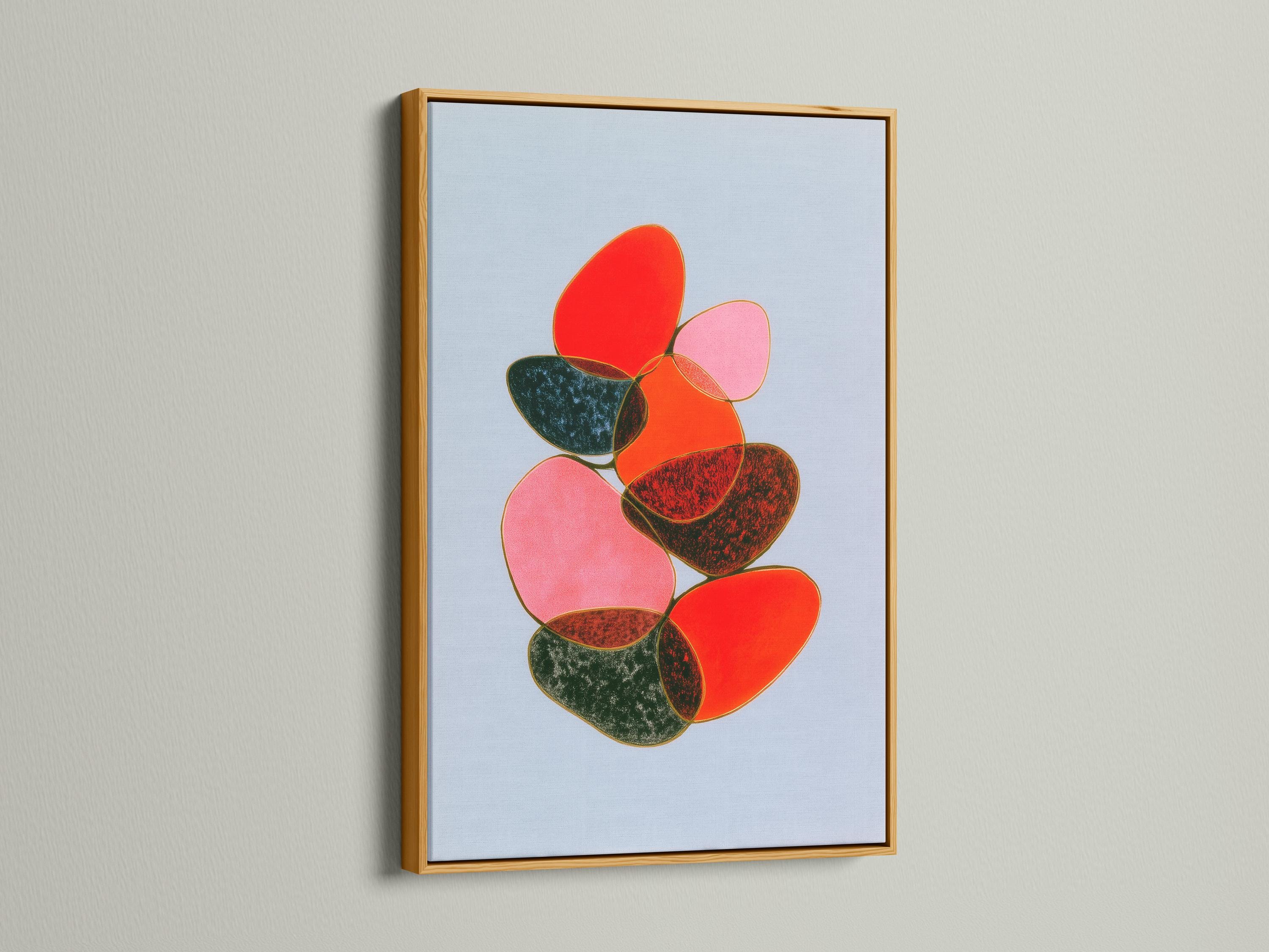 Room mockup showing a framed abstract artwork with overlapping red, pink and green shapes on a light blue background