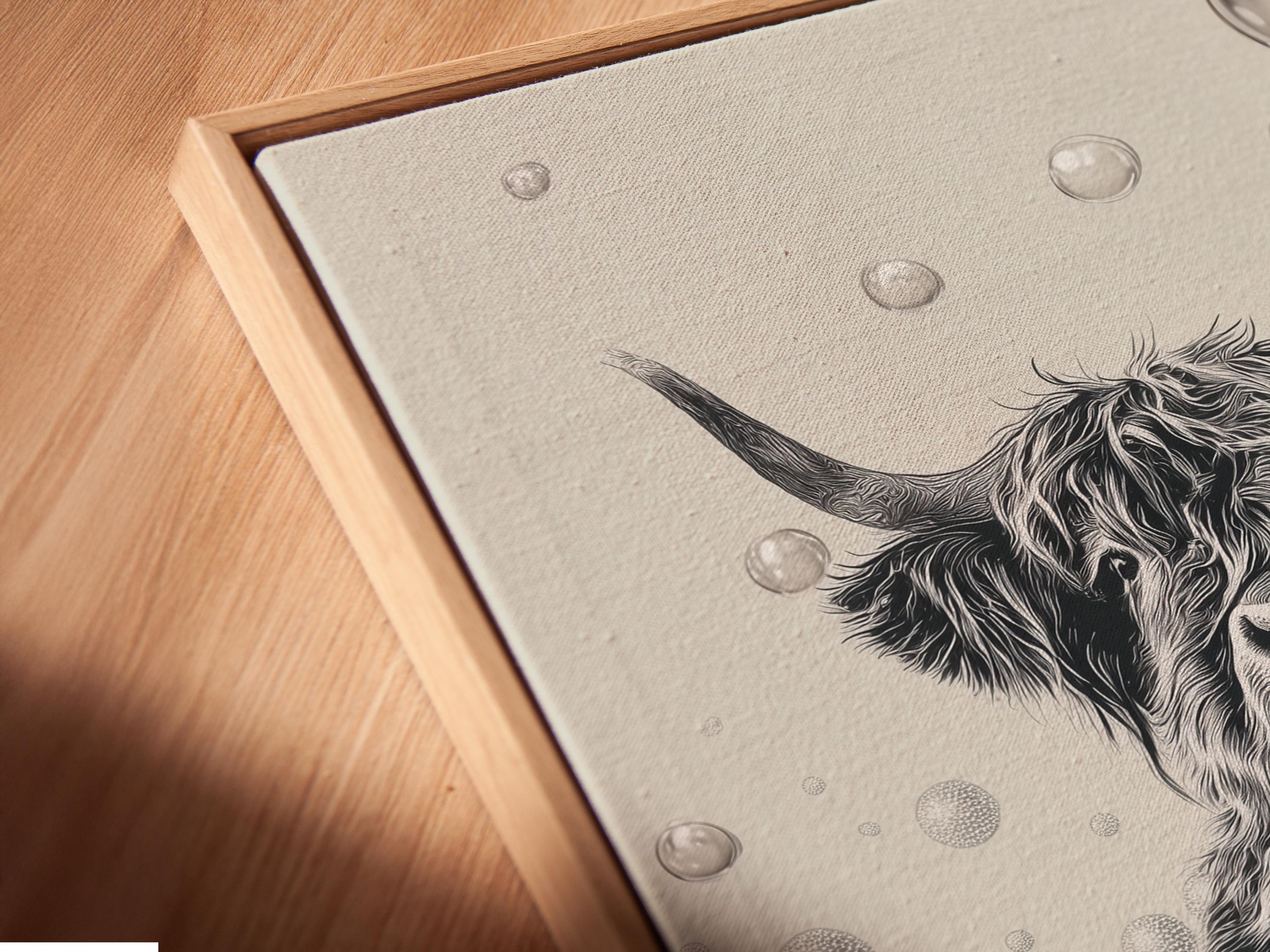 Woman holding a mug standing beside a framed monochrome highland cow bathtub artwork