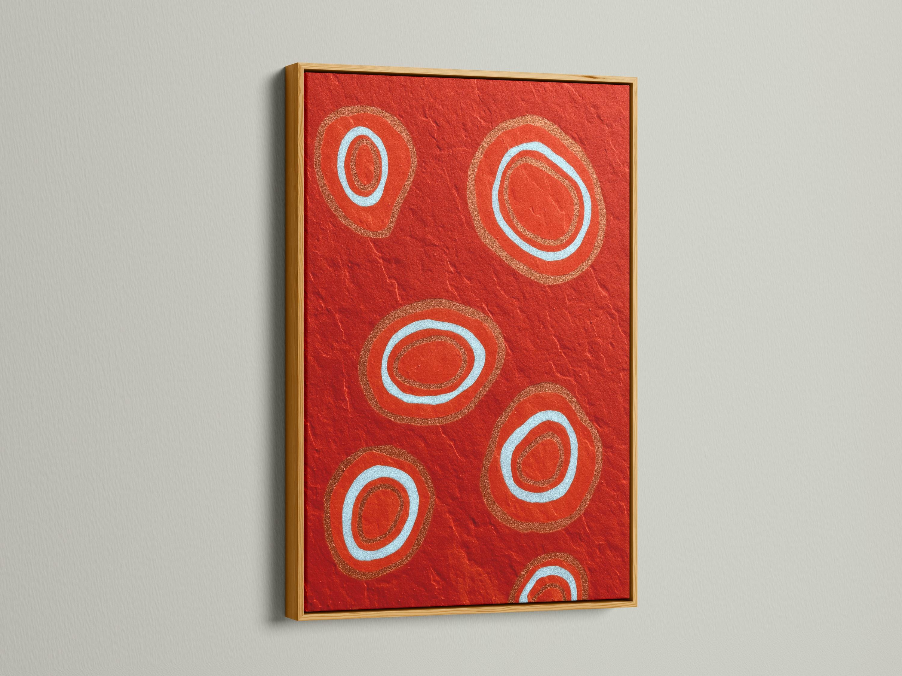 Room mockup showing a red abstract artwork with concentric circle motifs in pale blue and copper tones