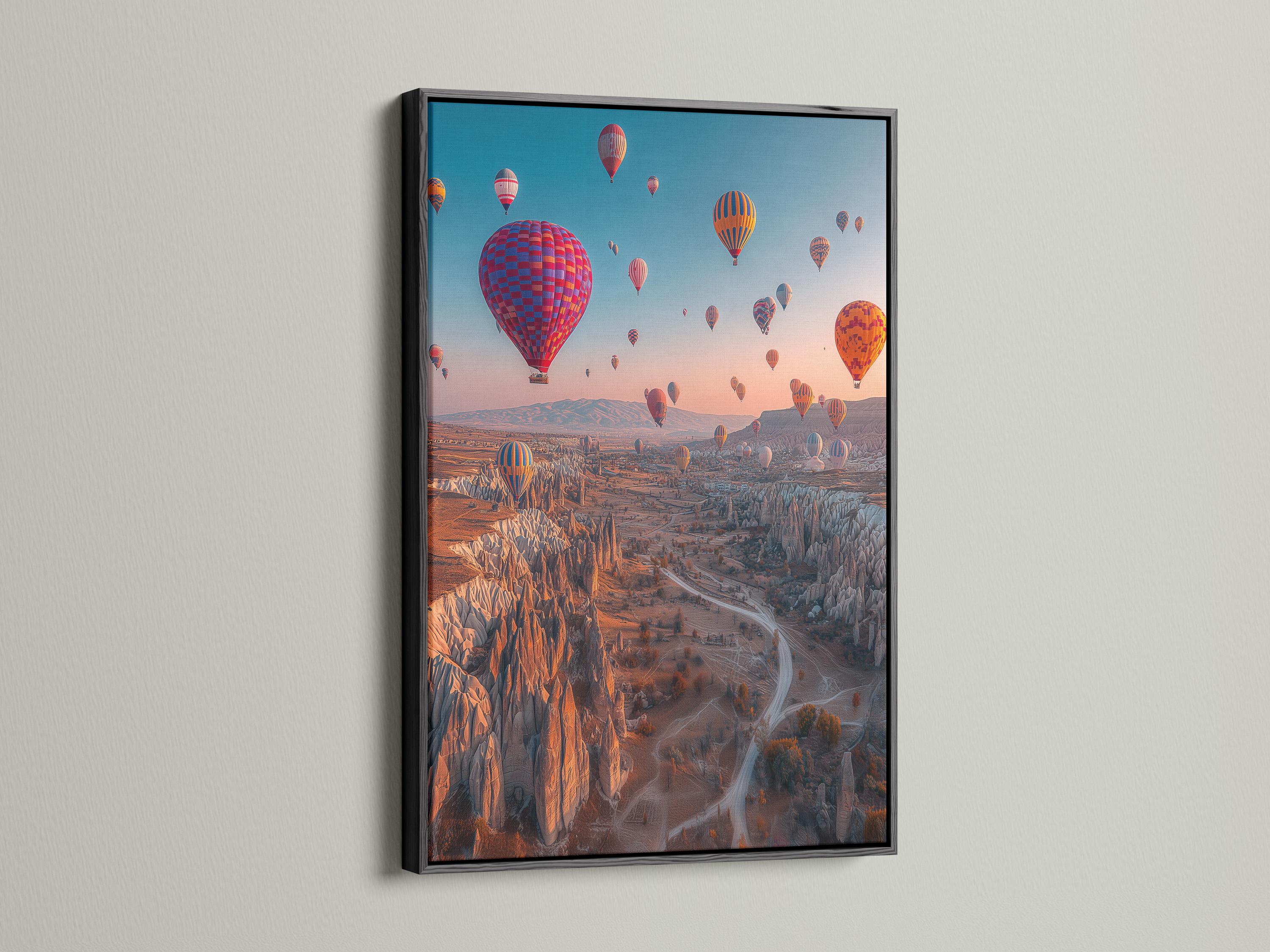A dusk landscape with multiple colourful hot air balloons in the sky over a rocky valley detail view