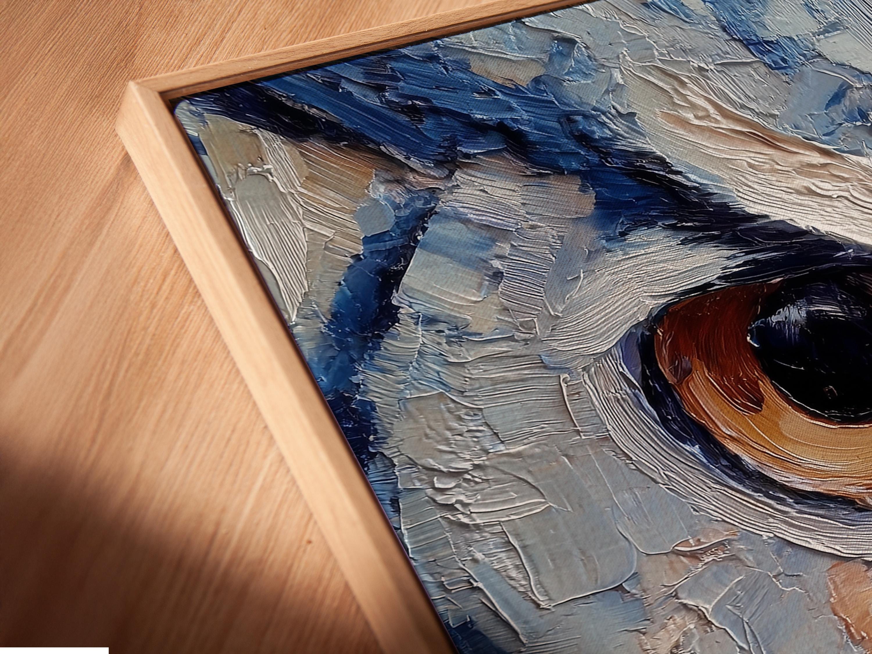 Room scene with a framed blue owl painting above a desk where a person writes in a book