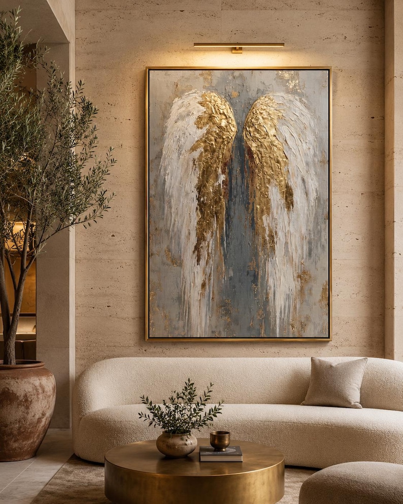 An angel-wing motif is shown symmetrically in layered white, grey and gold leaf-like tones, set against a textured neutral background
