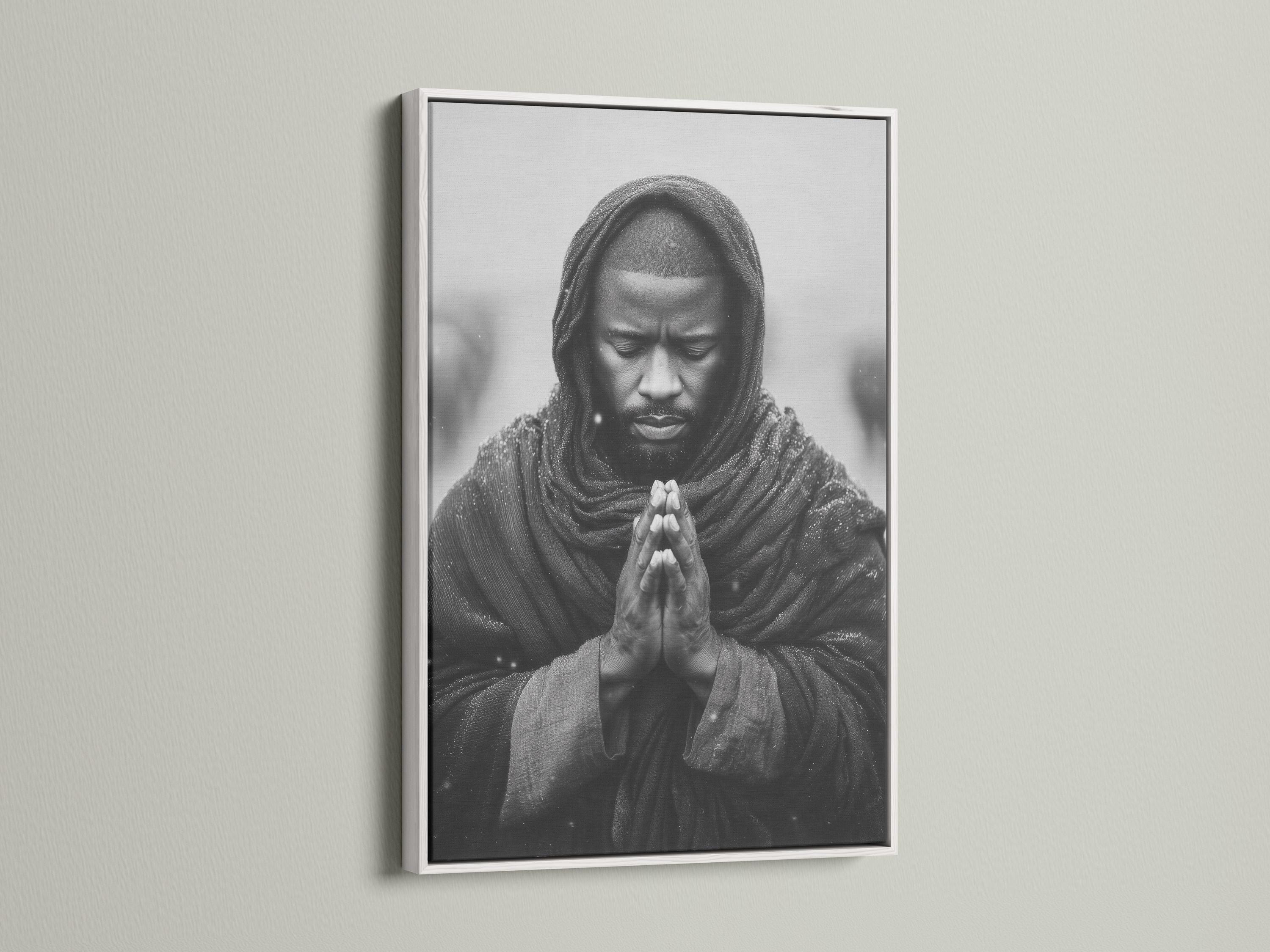 Room mockup showing a framed monochrome praying man portrait on a light background