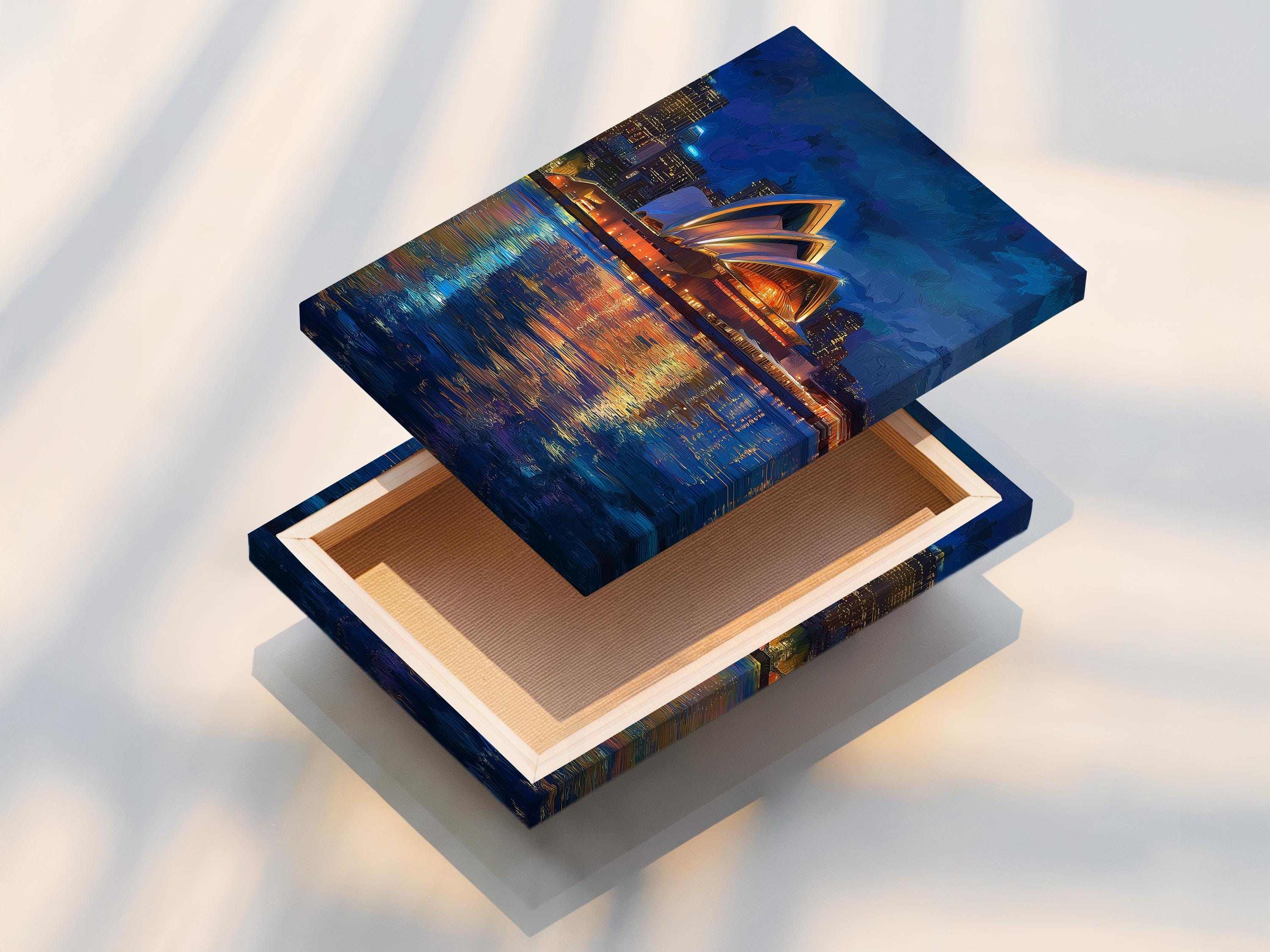 Framed night cityscape artwork featuring a glowing building and reflected lights on water