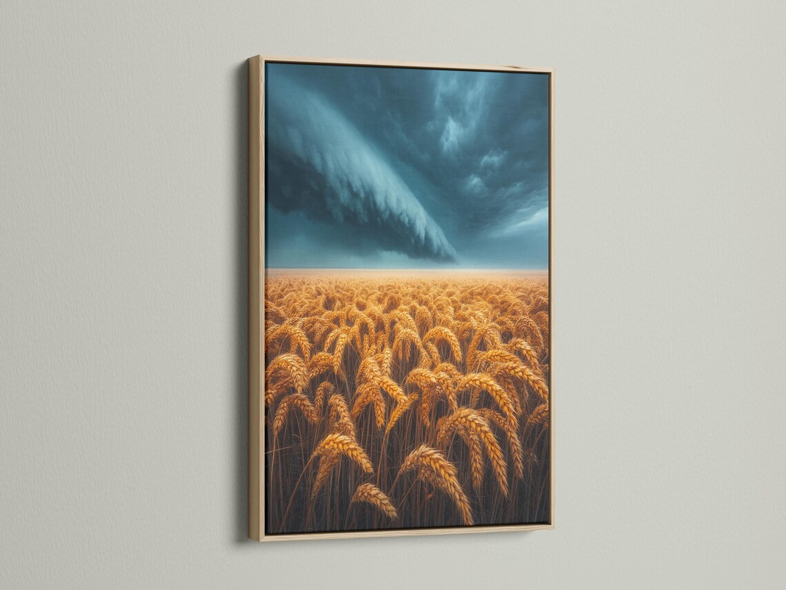 Golden wheat field under a stormy blue-grey sky with sweeping clouds and a bright horizon band detail view