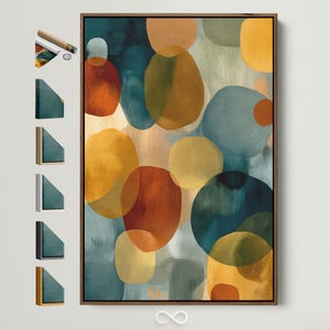 Puede incluir: Impresión artística abstracta con formas orgánicas superpuestas en tonos de verde azulado, naranja y amarillo. La obra de arte está enmarcada en un marco de madera oscura. La impresión tiene una estética moderna y minimalista.