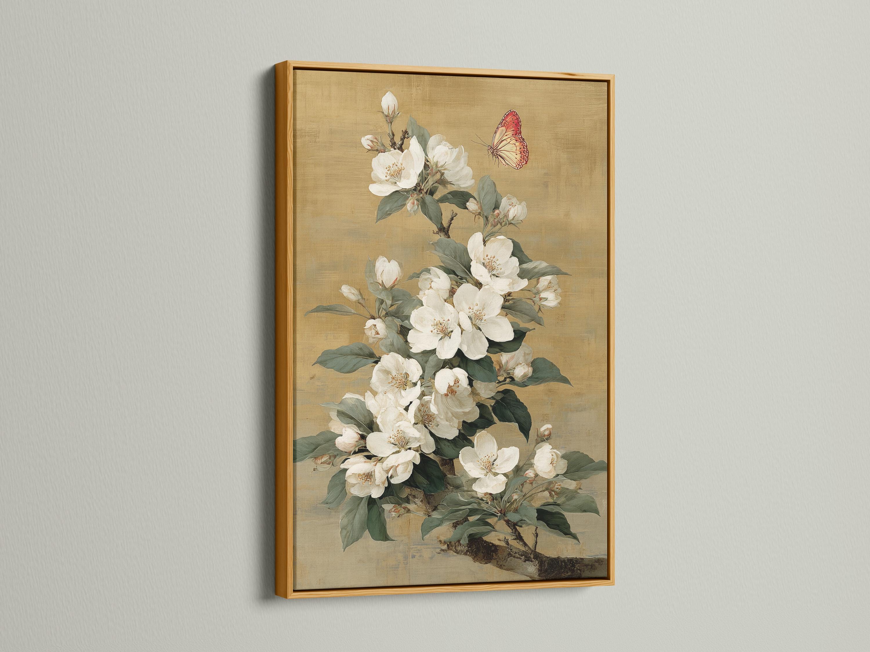 Vertical framed artwork mockup on a light wall with a bouquet of white blossoms and a butterfly
