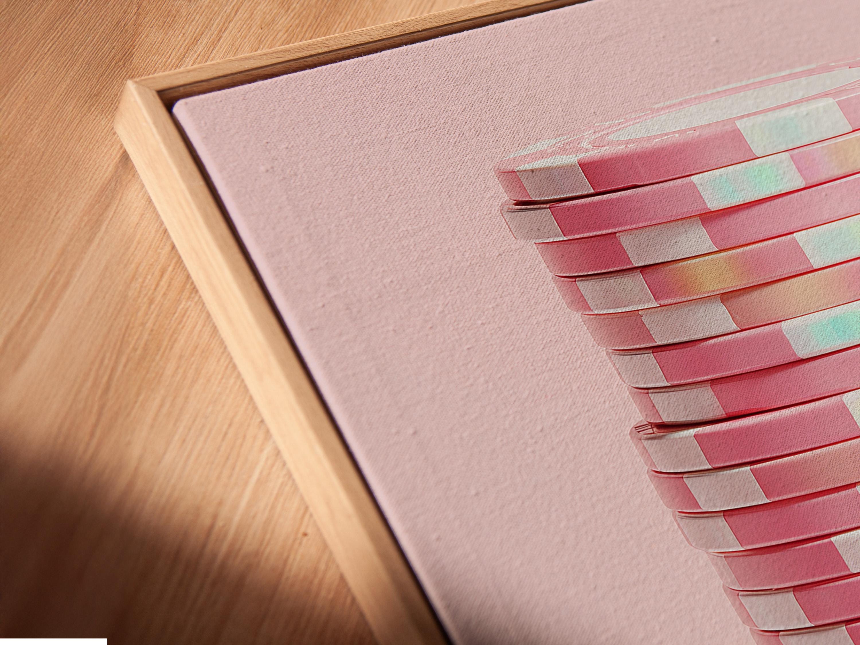 Pastel pink abstract artwork showing stacked disc shapes with subtle iridescent highlights detail view