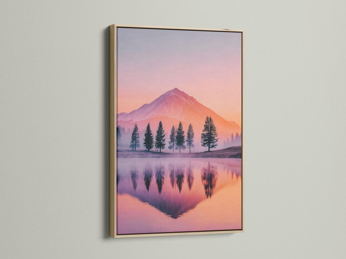 A pastel mountain landscape at sunset shows a pink-orange sky, a prominent mountain, silhouetted evergreen trees, and a calm mirrored lake reflection