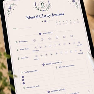 Peut inclure: Un journal numérique de clarté mentale affiché sur une tablette. Il comprend des sections pour l'humeur, la clarté, le stress, les priorités et les actions conscientes. Le design présente des éléments floraux et le texte "Mental Clarity Journal".