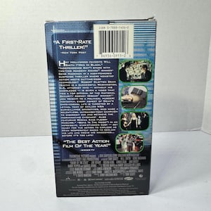 May include: A white ceramic mug with a black handle and the text "But First, Coffee" in a black, bold font. The mug is on a white surface.