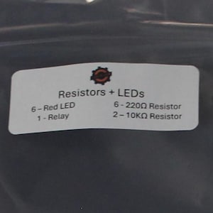 May include: An assortment of electronic components, including red LEDs, resistors, and a relay module. The components are arranged on a white surface, with a label indicating the contents of the package. Ideal for electronics projects.