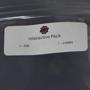 May include: An "Interactive Pack" with a PIR sensor and an L298N module. The pack is in a sealed plastic bag. Also included is a motion sensor and a red and blue circuit board with various electronic components.