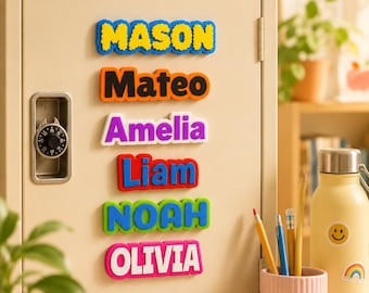 May include: Six rectangular name magnets attached to a beige metal locker door. The magnets feature the names MASON, Mateo, Amelia, Liam, NOAH, and OLIVIA in various bright colors including yellow, orange, purple, blue, green, and pink.