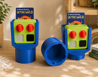 May include: Two blue plastic holders each containing a lime green electronic device with two red knobs, a white speaker mesh, and a black square. Each device displays a card labeled 5-Minute Stories IN THE WILD. A blue cylindrical cap sits between them.