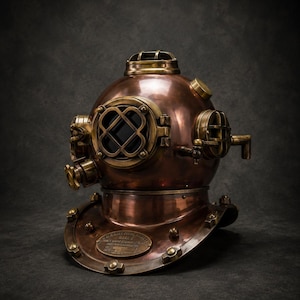 May include: A vintage copper diving helmet with brass detailing. The helmet has a circular faceplate with a cross-shaped window, air valves, and a neck ring. The aged appearance suggests it has been used. A decorative item for those interested in nautical history.