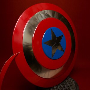 May include: A red, silver, and blue shield with a black star in the center. The shield is round with a red outer ring, a silver middle ring, and a blue center. The shield is displayed on a black stand.