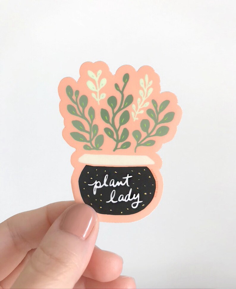 May include: A pink and black sticker with a potted plant and the text "plant lady".
