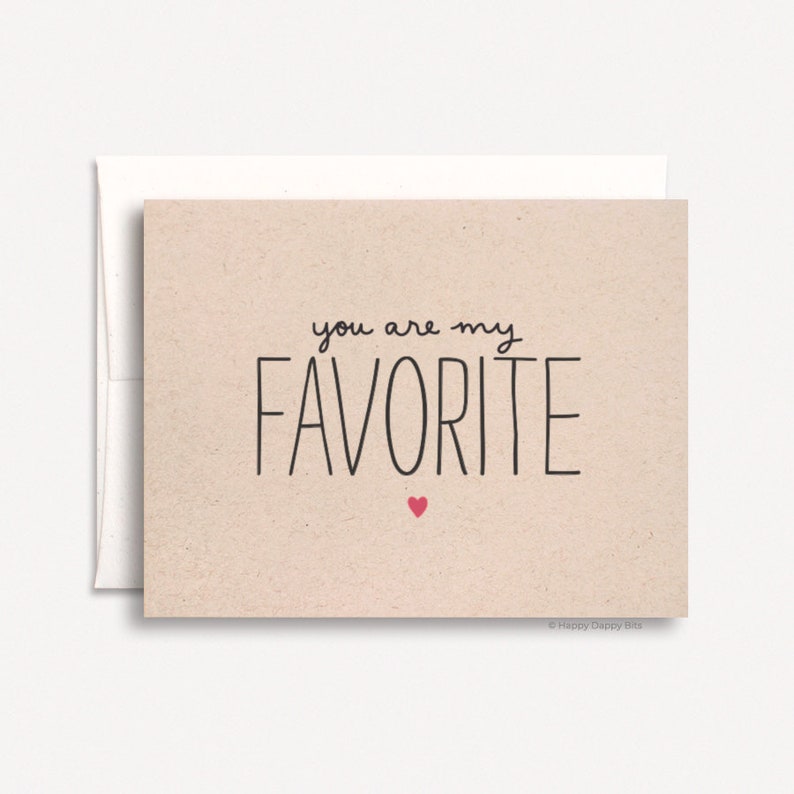 May include: A card with a beige background and black text that reads "you are my favorite" with a small red heart below the text. The card is signed "Happy Daffy Bits".