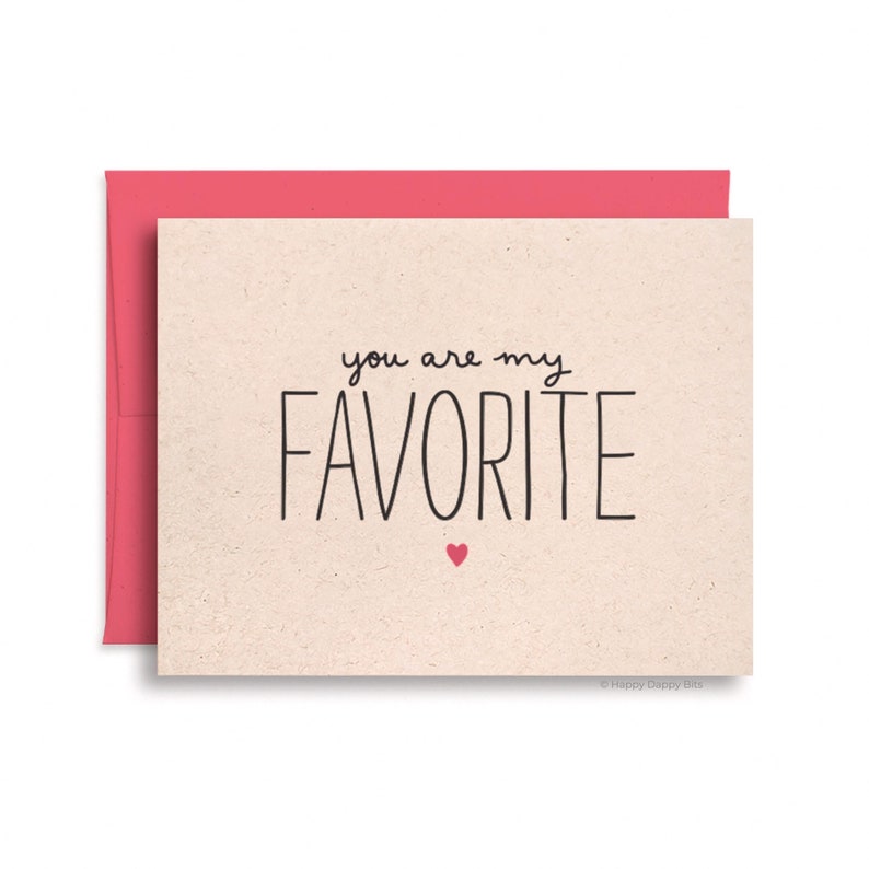 May include: A card with a beige background and a pink envelope. The card says "You are my favorite" in black script with a small pink heart at the bottom.