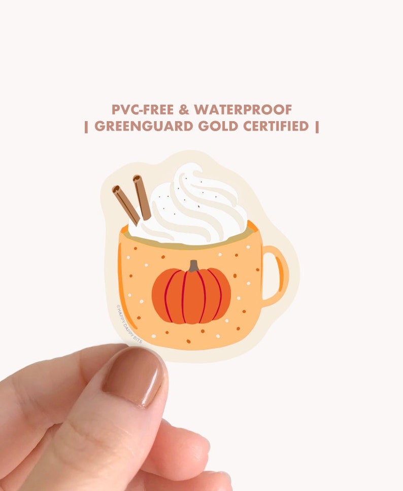 May include: A sticker of a pumpkin spice latte with whipped cream and cinnamon sticks in a mug with a pumpkin on the front. The sticker is labeled "PVC-FREE & WATERPROOF | GREENGUARD GOLD CERTIFIED |"