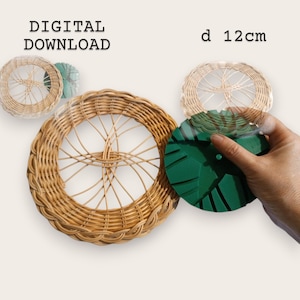 May include: Woven wicker plate, diameter 12cm. The plate is a natural tan colour and has a radial spoke design. A green object is held near the plate. The text "DIGITAL DOWNLOAD" and "d 12cm" are visible.