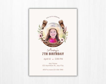 May include: A birthday invitation card featuring a horseshoe frame decorated with watercolor flowers. Inside the horseshoe is a photo of a child wearing a cowboy hat. The text reads: Join us to celebrate, Avery's 7TH BIRTHDAY, April 12, 2:00 PM, Any Venue, 123 Anywhere St., Any City, RSVP to mom 123-456-7890.