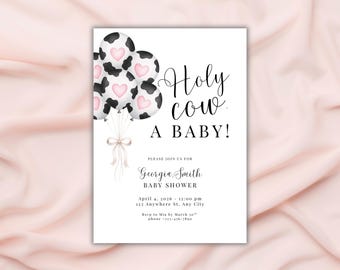 May include: A baby shower invitation with the phrase "Holy cow, A BABY!" in black script. The invitation features balloons with black and white cow spots and pink heart accents. The invitation includes the name Georgia Smith, date, time, and location.