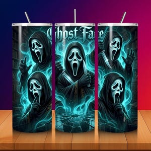 May include: A cylindrical tumbler featuring a repeating graphic of the Ghost Face character in a black hooded robe with a white mask, surrounded by glowing blue smoke and shards of glass. The text Ghost Face is printed in a gothic font.
