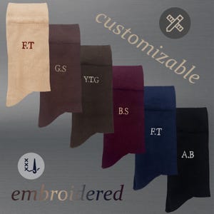 May include: A collection of six socks in various colors, including beige, brown, burgundy, navy, and black. Each sock is embroidered with initials in white. The word "customizable" is written diagonally across the image, and the word "embroidered" is at the bottom.