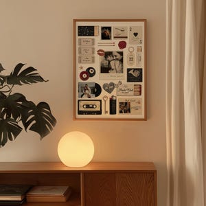 May include: A warm, glowing orb lamp sits on a wooden cabinet, below a framed collage of vintage photos and ephemera. The collage includes a photo of a couple, a cassette tape, and a heart-shaped sticker.