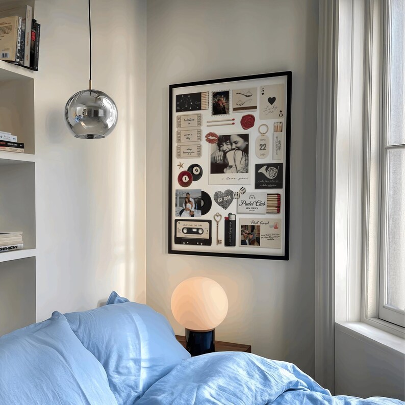May include: A bedroom scene featuring a large framed collage of photos and memorabilia. A silver orb pendant light hangs from the ceiling. A round, white globe lamp sits on a dark base. The bed is covered with light blue bedding.