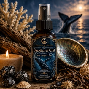 May include: A 2 fl oz amber glass spray bottle labeled Loon Lake Apothecary Guardian of Grief Whale Ocean Spray. The label features a whale illustration, gold filigree, and text including Hold, Honor, Carry and Grief is love with nowhere to go.