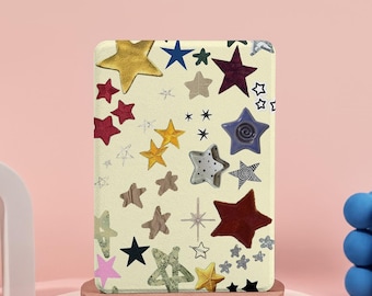 May include: An off-white rectangular case decorated with an assortment of colourful stars. The stars are in gold, red, blue, and silver, some with unique patterns. The case is displayed on a small, round, brown pedestal.