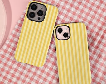 May include: Two yellow and light yellow striped phone cases. The cases have black borders and are on a red and white checkered surface. The phone cases are for a smartphone.