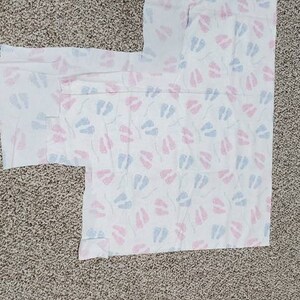 Baby&#39;s first Christmas (remnant) pink.  Blue.  Footprint.  Flannel.