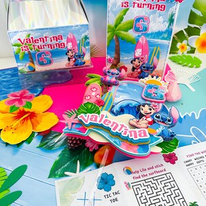 May include: A party set with a tropical beach theme, featuring the text "Valentina is turning 6". The set includes a gift box, treat bags, and decorations with Lilo & Stitch characters, surfboards, and flowers. There is also a tic-tac-toe game and a maze.