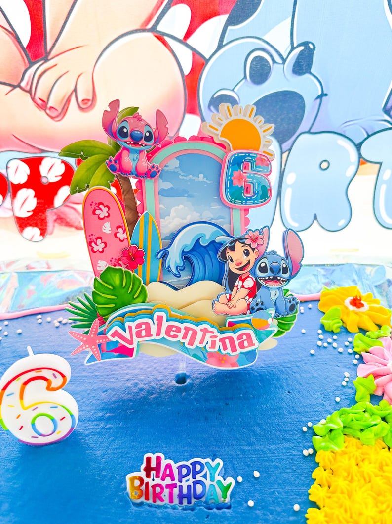 May include: A blue birthday cake decorated with a tropical theme. The cake features a topper with the name "Valentina", the number "6", and characters from the animated film Lilo & Stitch. The words "Happy Birthday" are also visible.
