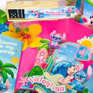 May include: A party display with a wooden domino set and themed decorations. The scene includes a pink backdrop, cartoon characters, surfboards, and the name "Valentina". The text "Thank you for coming" is also visible.