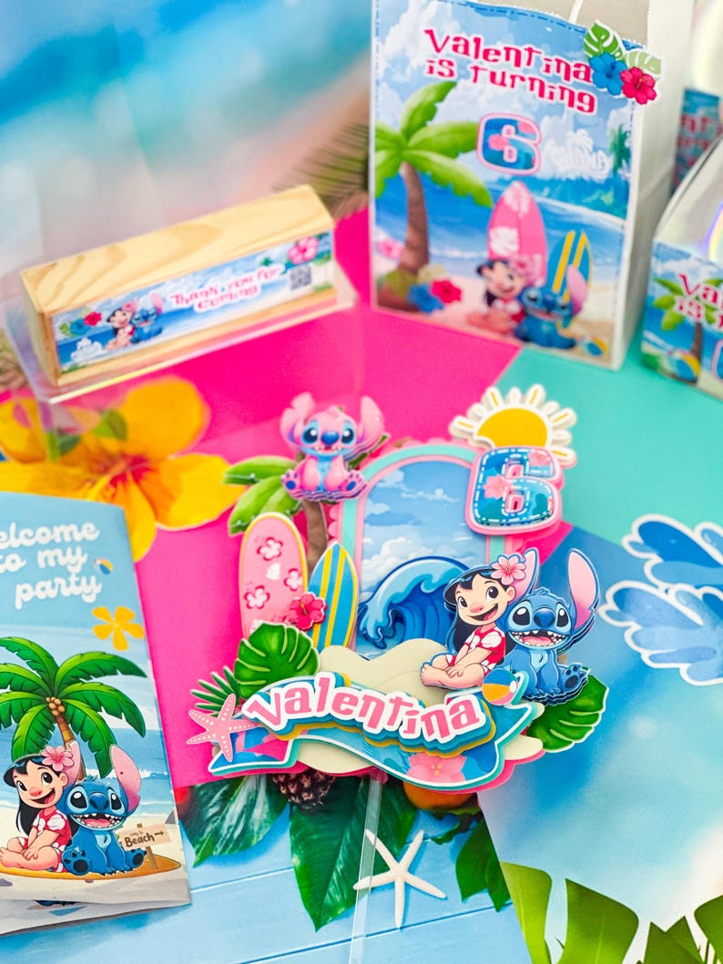 May include: A vibrant birthday party display with Lilo & Stitch decorations. The focal point is a cake topper with the name "Valentina" and the number 6. Party bags and a wooden box with text are also present.