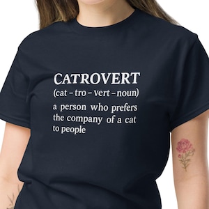 May include: Navy blue t-shirt with the word "CATROVERT" in white, along with a definition: "a person who prefers the company of a cat to people."