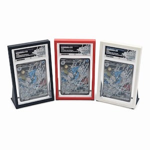 May include: Three framed Kingdra EX trading cards, each encased in a protective holder. The frames are black, red, and white, with the cards featuring a blue and silver illustration. Each card is graded 10.