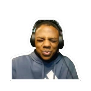 May include: A sticker featuring a person with closed eyes and pursed lips, wearing a blue hoodie and black headphones. The person's expression suggests a moment of intense focus or concentration. The sticker has a white border.