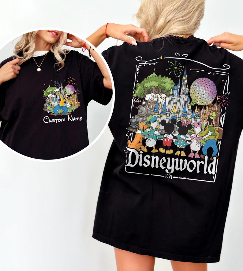 May include: Black t-shirt featuring a colorful Disney World graphic on the back, with the text "Disneyworld - 1971". The front of the shirt has a smaller graphic with the text "Custom Name". The design includes cartoon characters and fireworks.