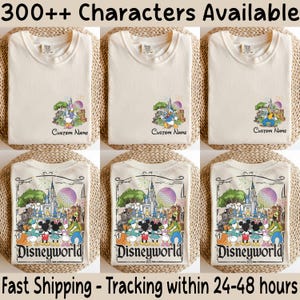 May include: Cream-colored t-shirts with Disney character graphics. Some shirts feature Donald Duck, Goofy, and other characters with the text "Custom Name." Other shirts display a larger "Disneyworld" graphic with Mickey and Minnie Mouse, and the text "1971."