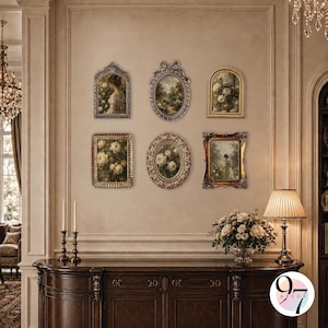 A gallery wall arrangement of six ornate picture frames hanging above a dark wooden console table with lamps and flowers.