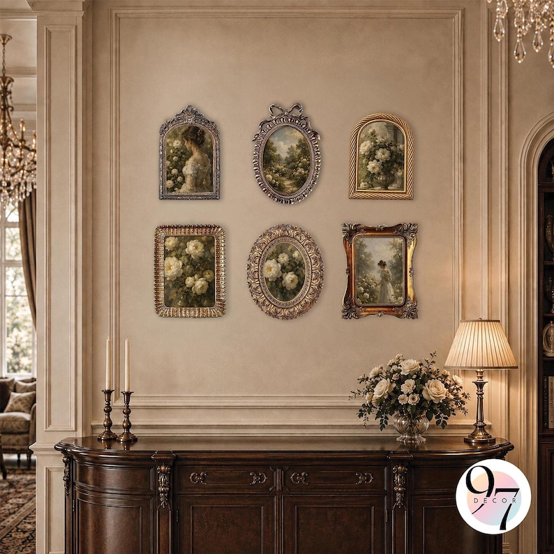 A gallery wall arrangement of six ornate picture frames hanging above a dark wooden console table with lamps and flowers.