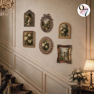 Six vintage-style ornate picture frames arranged symmetrically on a staircase wall next to a lit lamp.