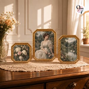 May include: Three octagonal gold-toned frames containing art prints. The left frame shows a floral bouquet, the center frame depicts a person in a light dress, and the right frame features a landscape with two white swans on a calm lake.